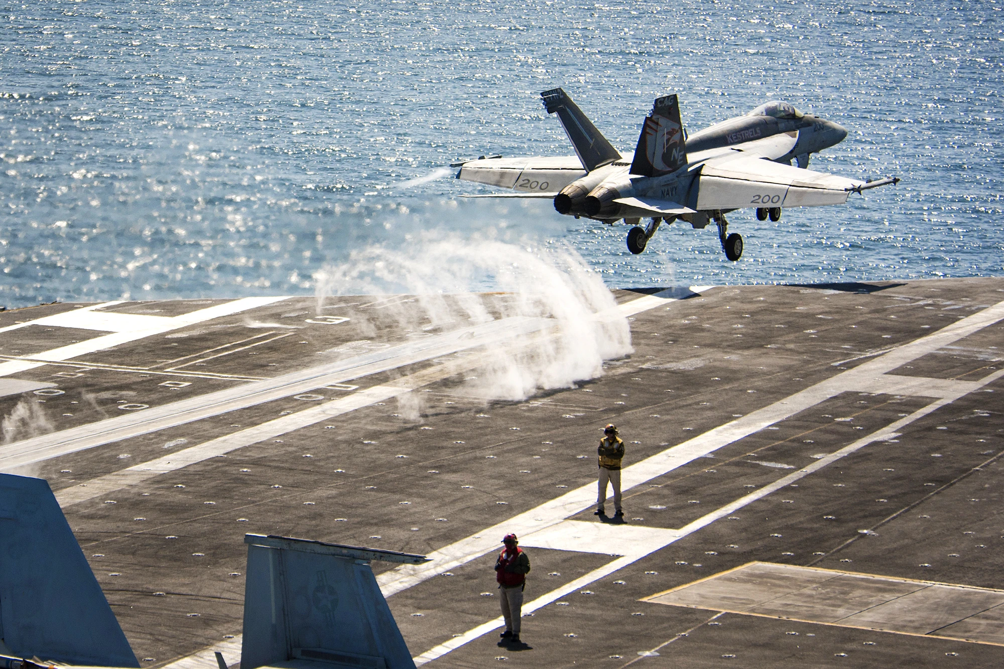 A U.S. Navy F/A-18E Super Hornet launching from USS Carl Vinson above catapult steam.